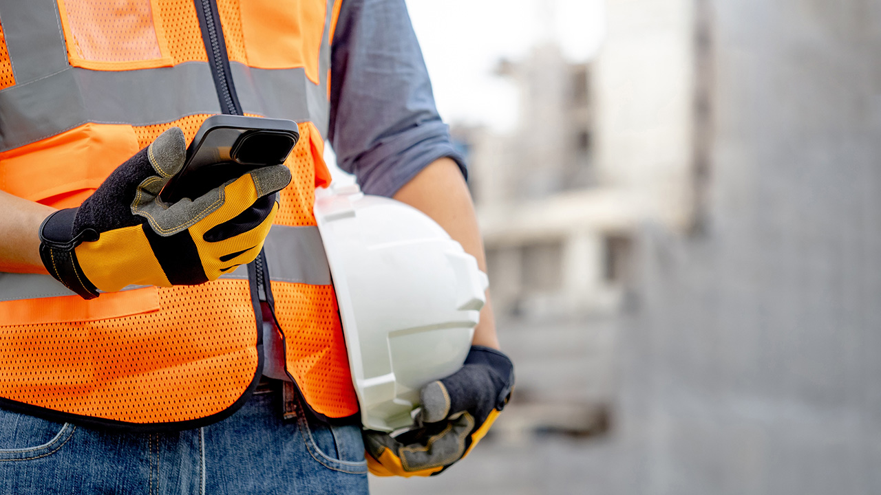 Construction,Worker,Man,With,Orange,Reflective,Vest,Holding,White,Protective Digital toolbox meeting